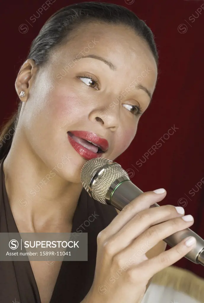 Woman singing into microphone