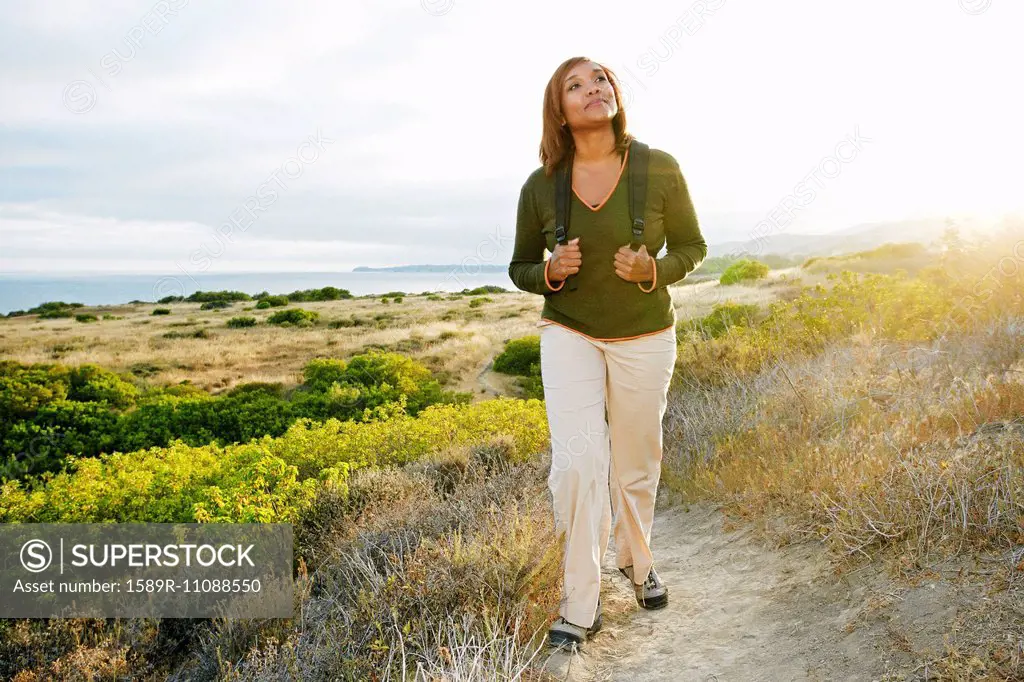 Black woman standing on rural hillside