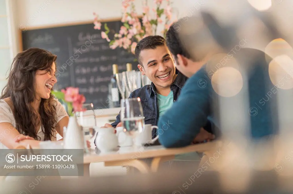 Hispanic friends talking in cafe