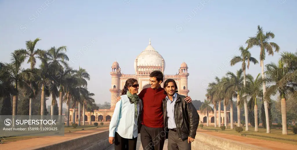Indian family walking by Safdarjang's Tomb, Delhi, India