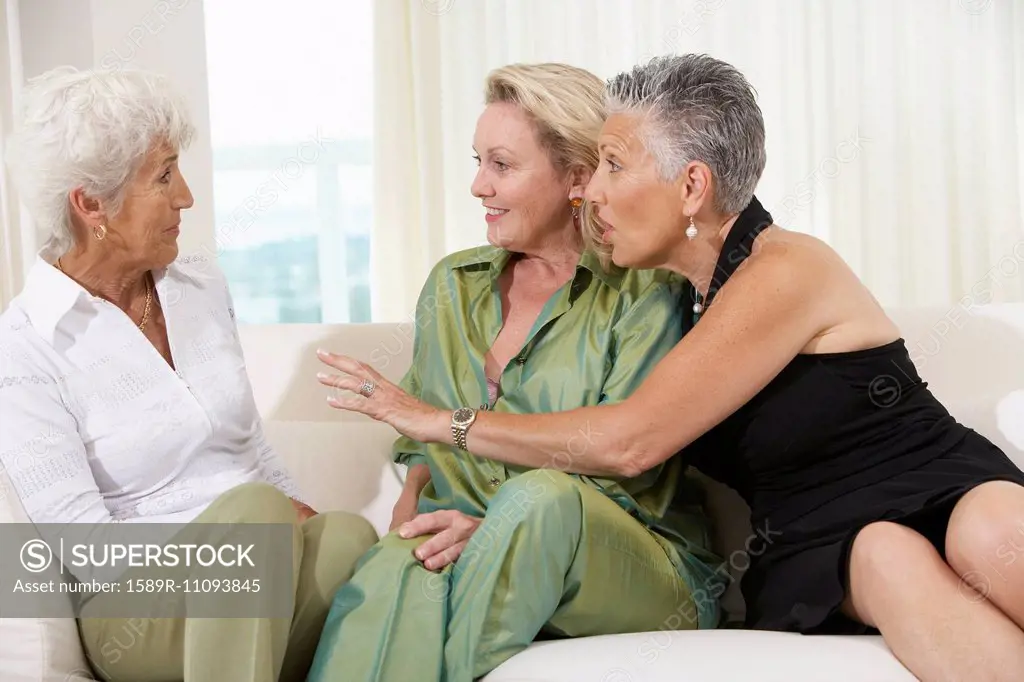 Senior women talking on sofa