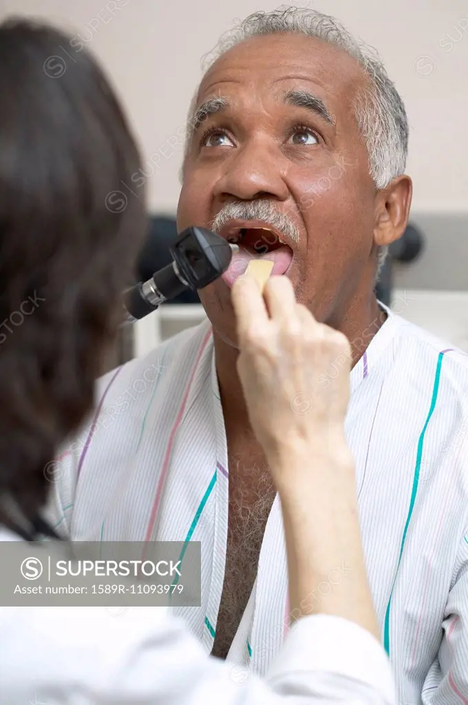 Doctor checking Senior man's tongue