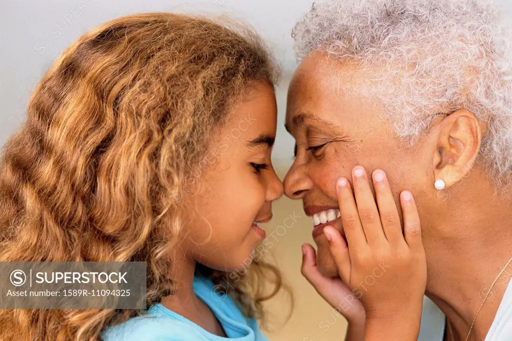 Senior woman and granddaughter touching noses