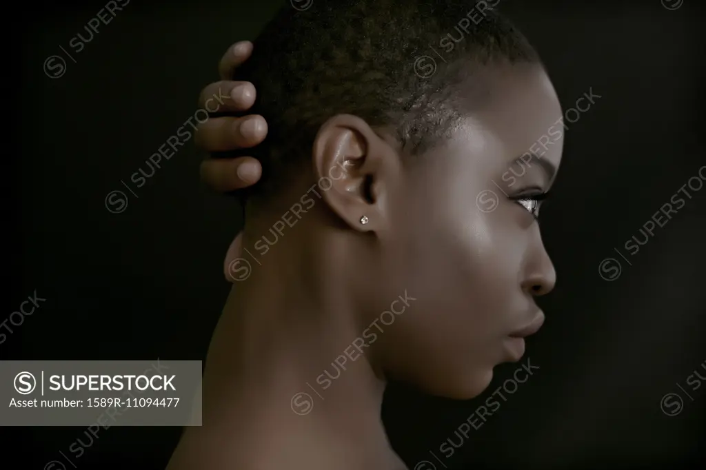 Black woman with hand behind head