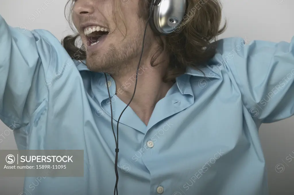 Young man singing wearing headphones