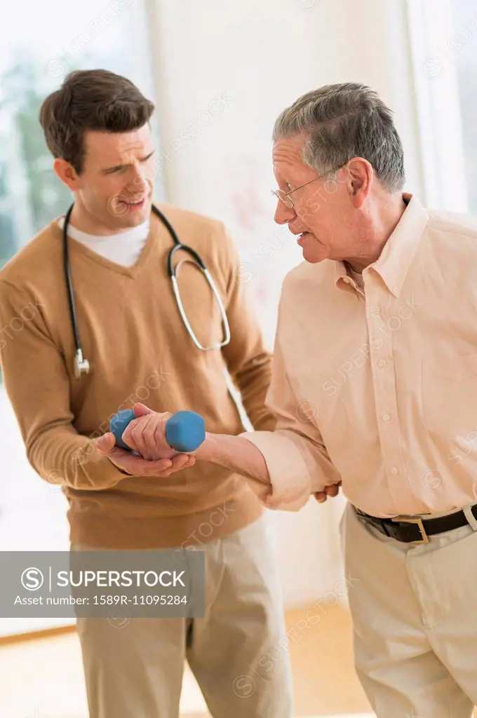 Senior Caucasian man working with physical therapist