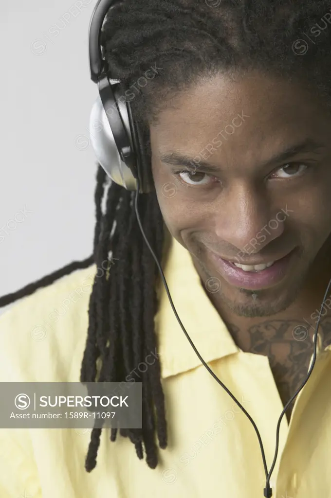 Portrait of a young man wearing headphones smiling