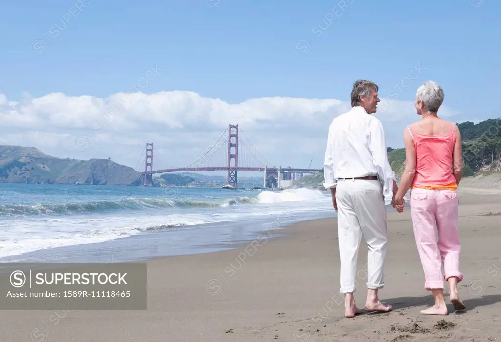 Senior Caucasian couple walking by Golden Gate Bridge, San Francisco, California, United States