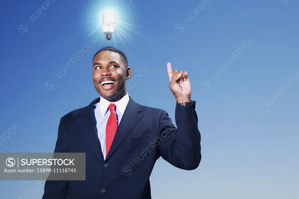 Mixed race businessman with light bulb over his head