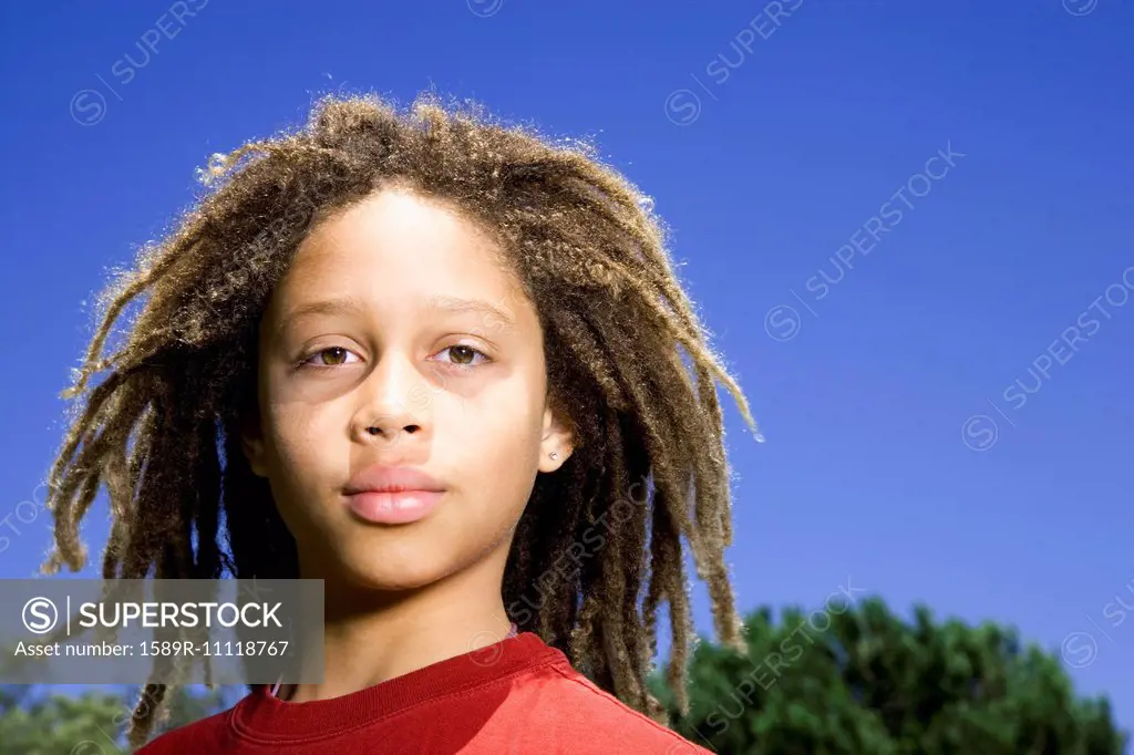 Mixed race boy standing outdoors