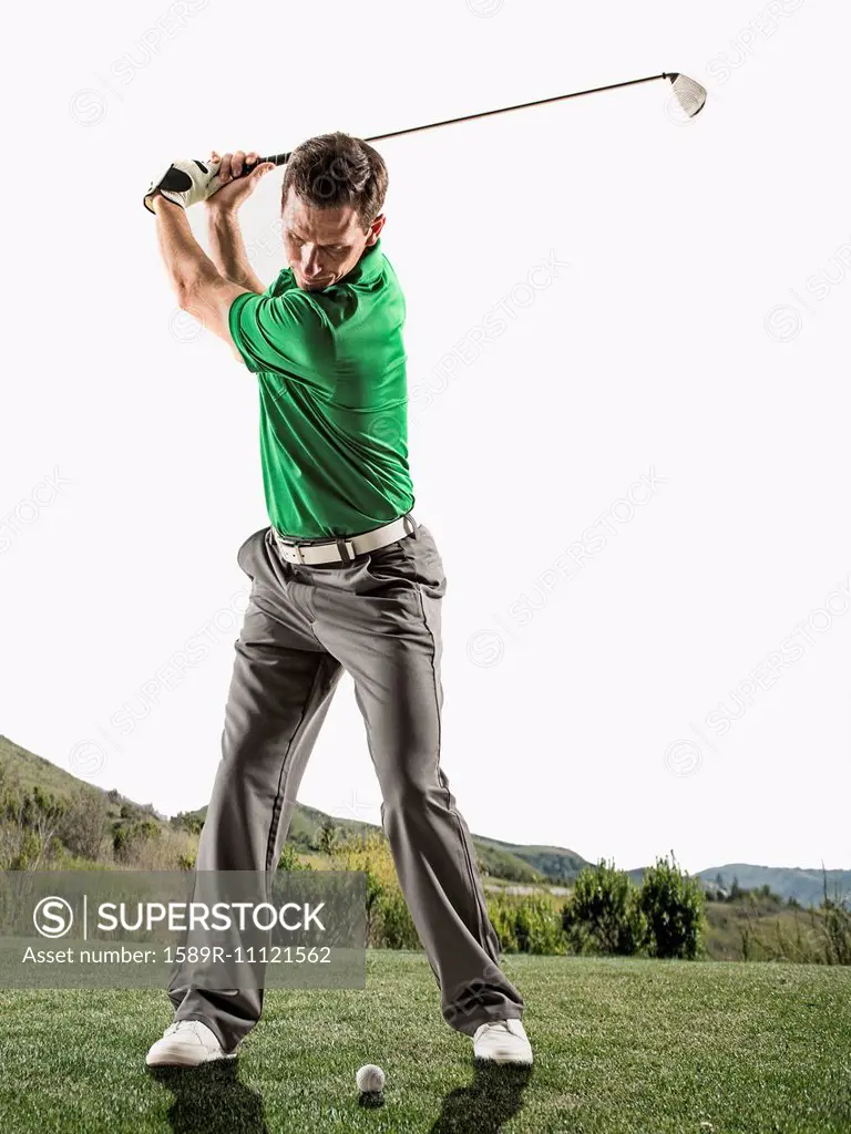 Caucasian man playing golf on course