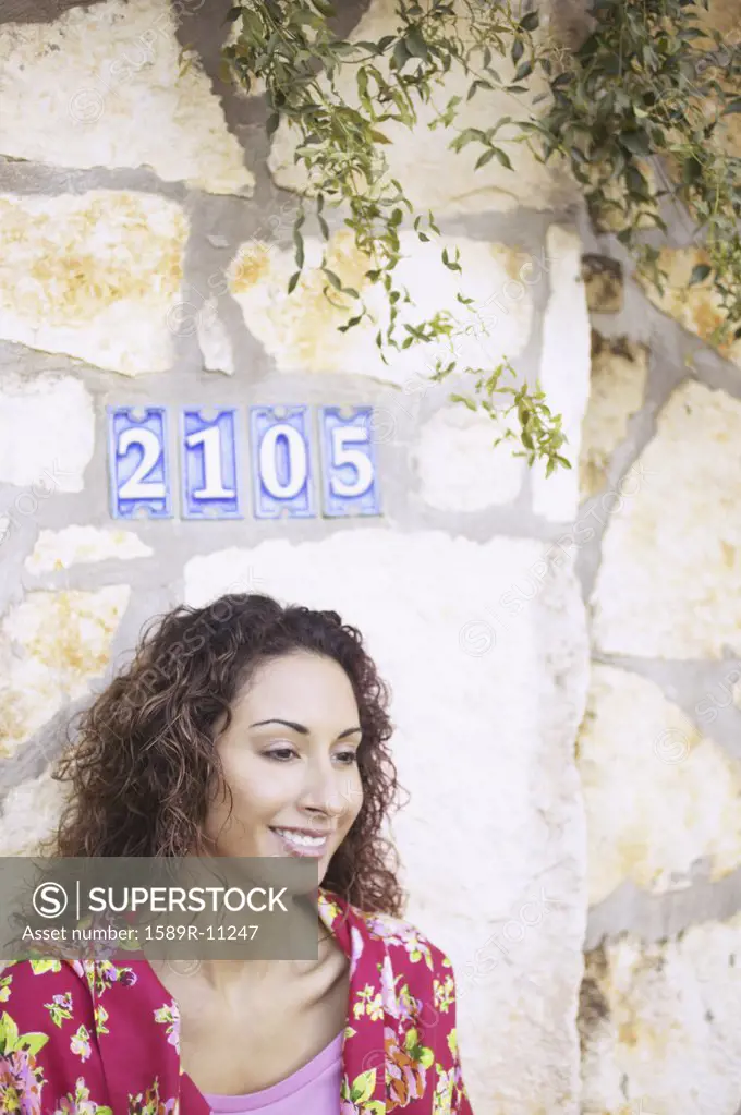 Woman standing in front of a stone wall