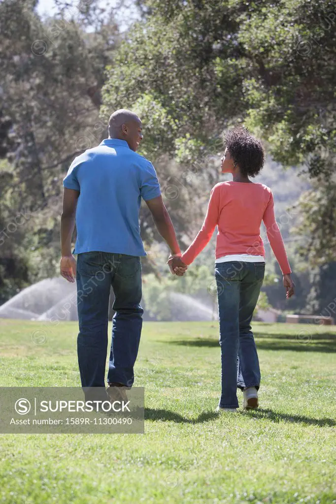 Couple holding hands in park