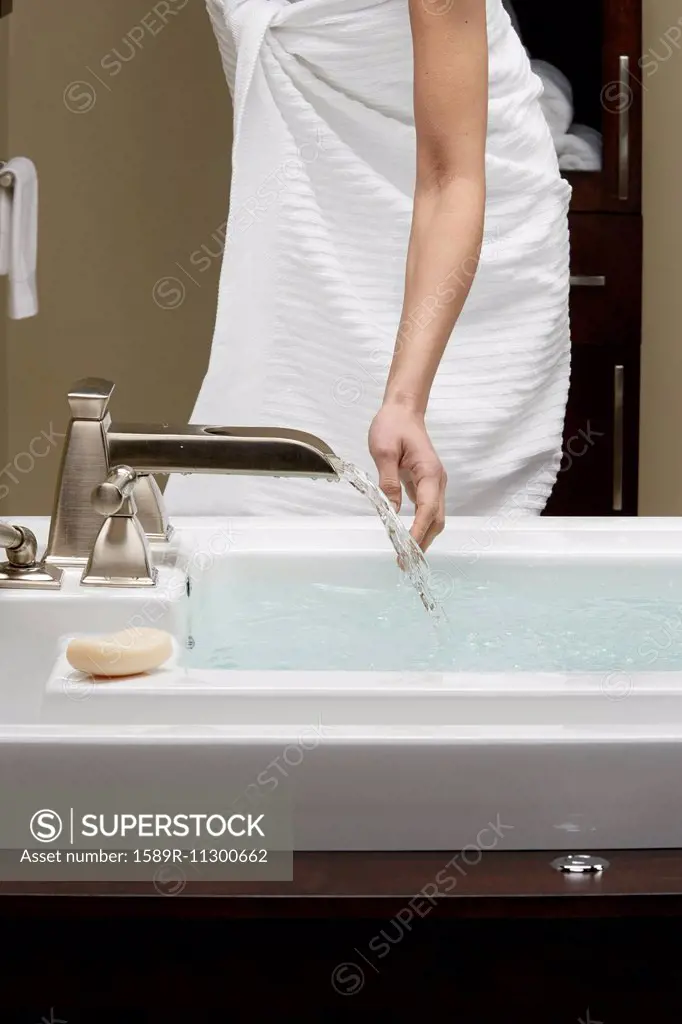 Caucasian woman running bath
