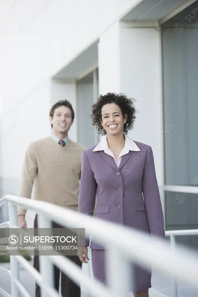 Business people smiling on walkway