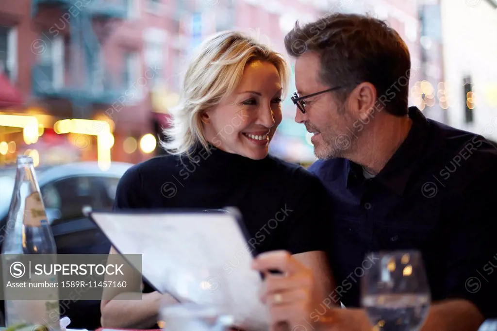 Caucasian couple eating at urban cafe, New York City, New York, United States