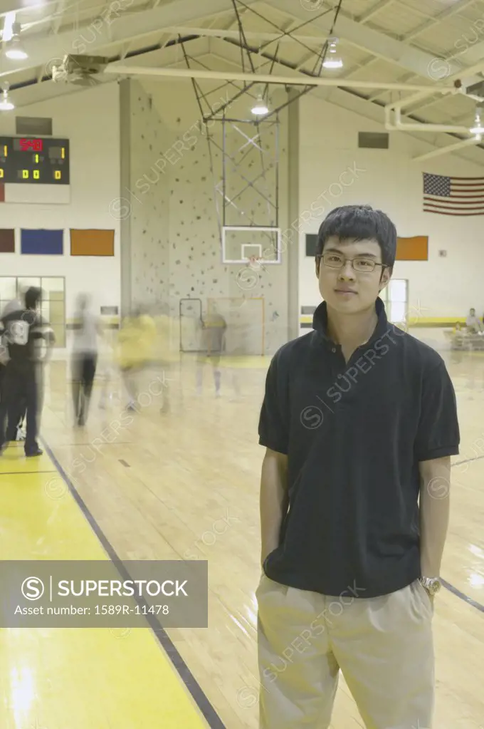 Teenage boy standing on basketball court