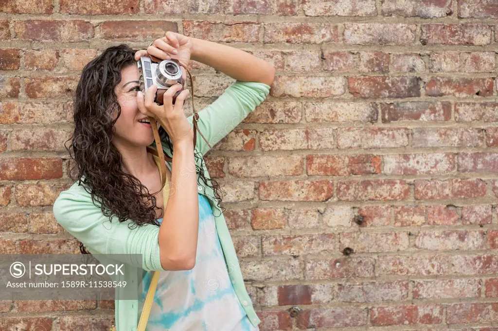 Mixed race woman photographing outdoors