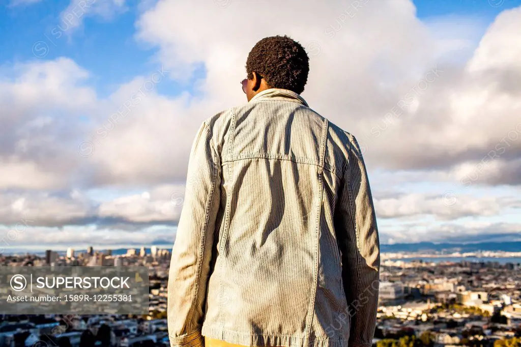 Black man looking at scenic view of cityscape