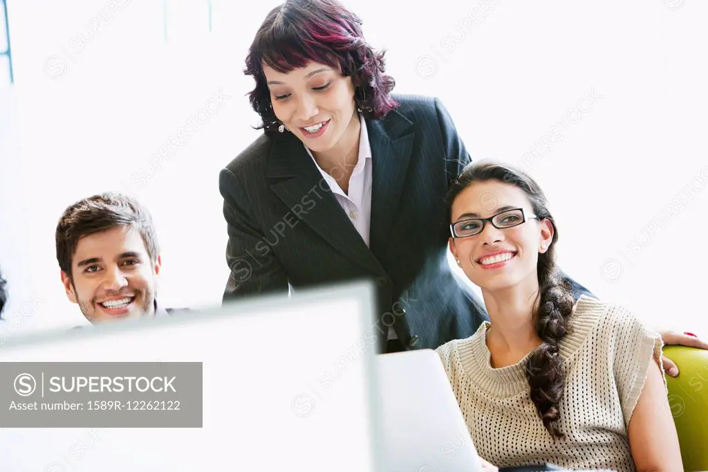 Hispanic business people working together in office