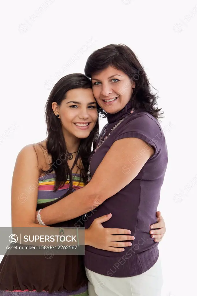 Hispanic mother hugging daughter