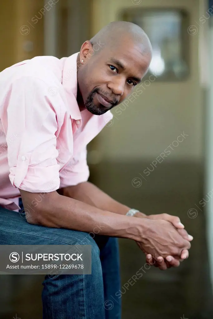 Serious Black man with hands clasped