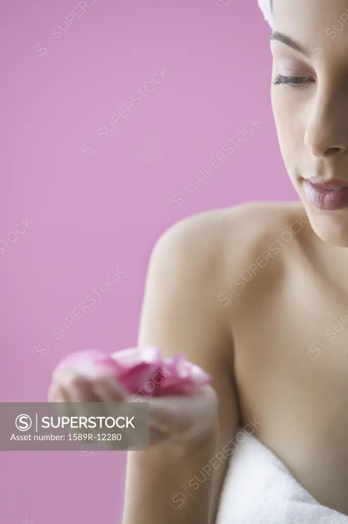 Closeup of teen girl holding rose petals