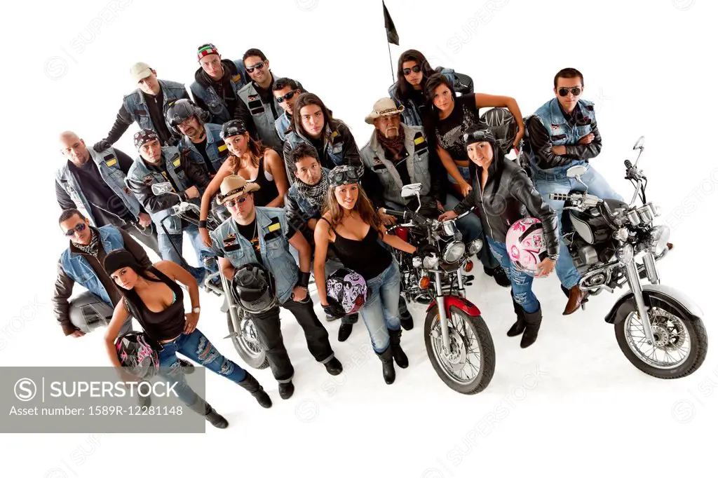 Hispanic bikers standing with motorcycles