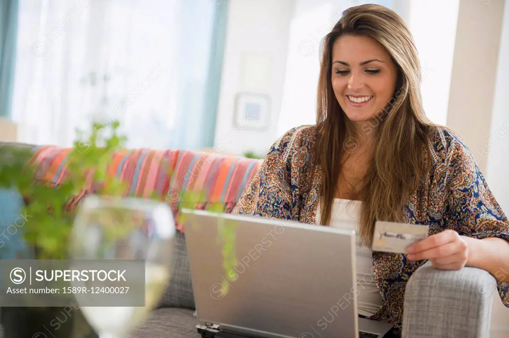 Caucasian woman shopping online with laptop