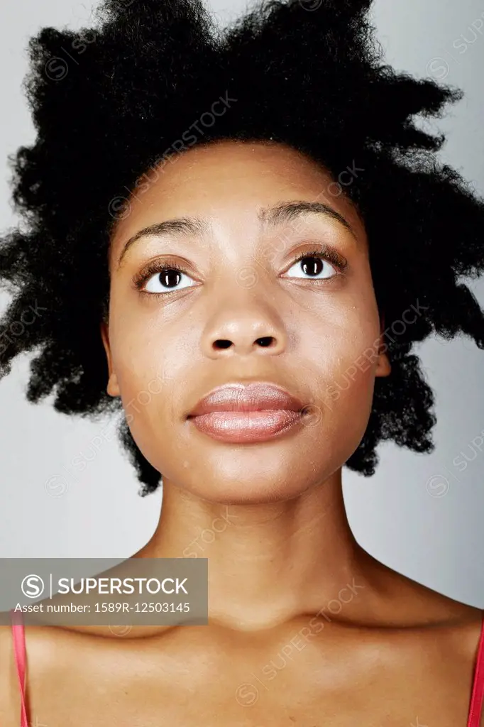 Close up of serious black woman looking up