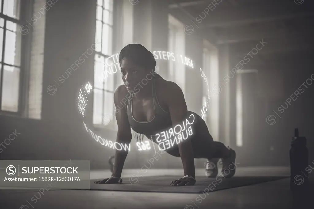 Virtual words circling Black athlete doing push-ups