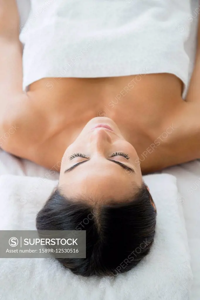Caucasian woman laying on massage table