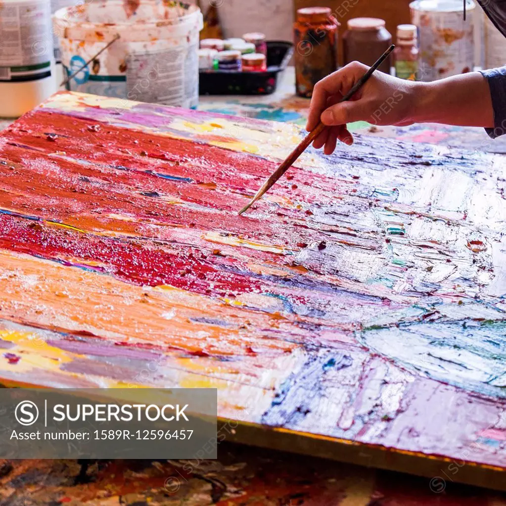 Mari artist painting canvas in studio