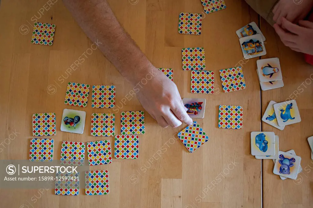 People playing tile game on wooden table