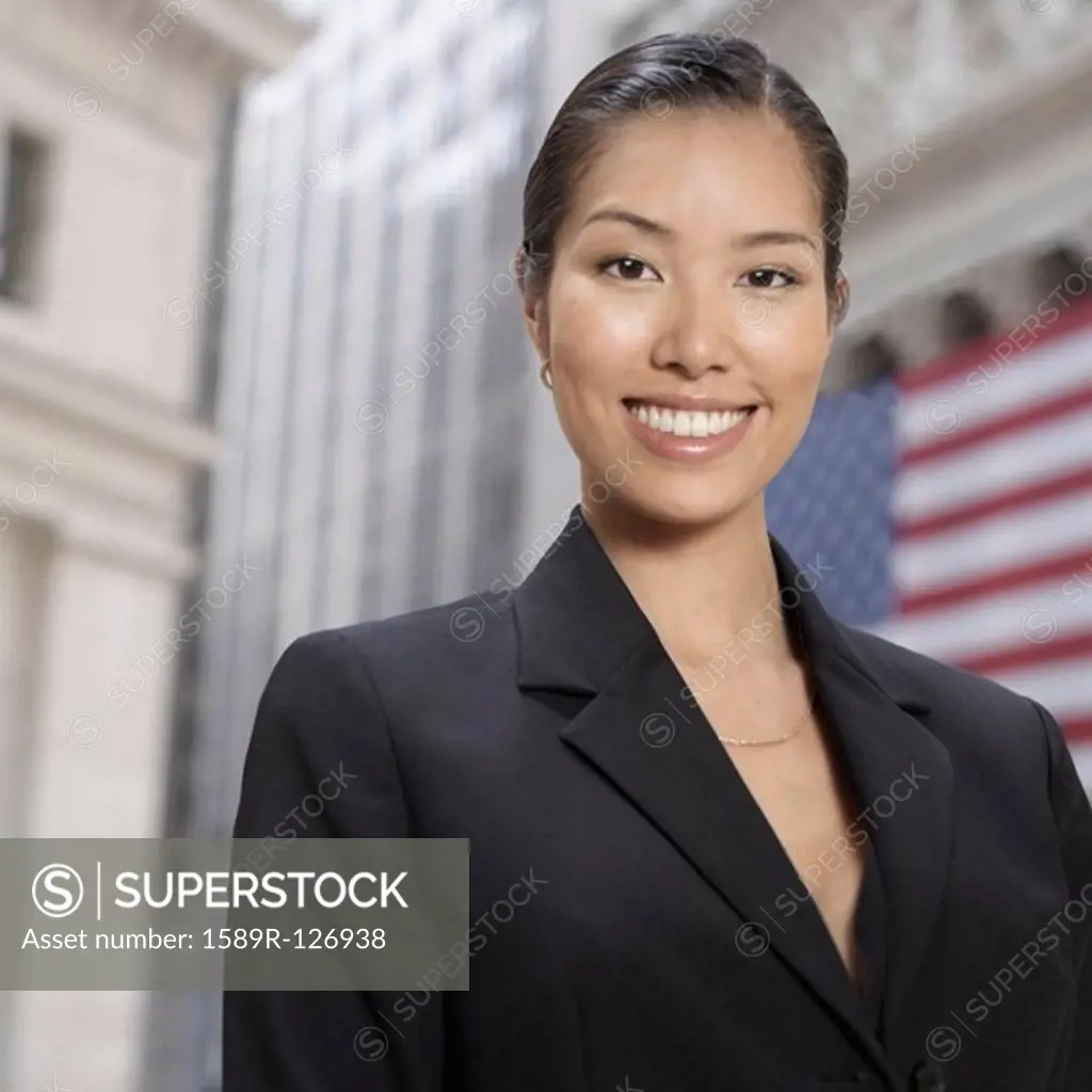 Asian businesswoman in front of American flag