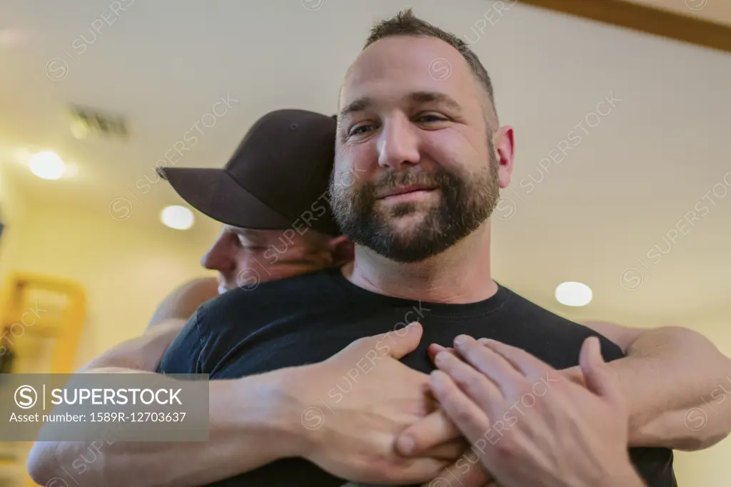 Close up of gay couple hugging