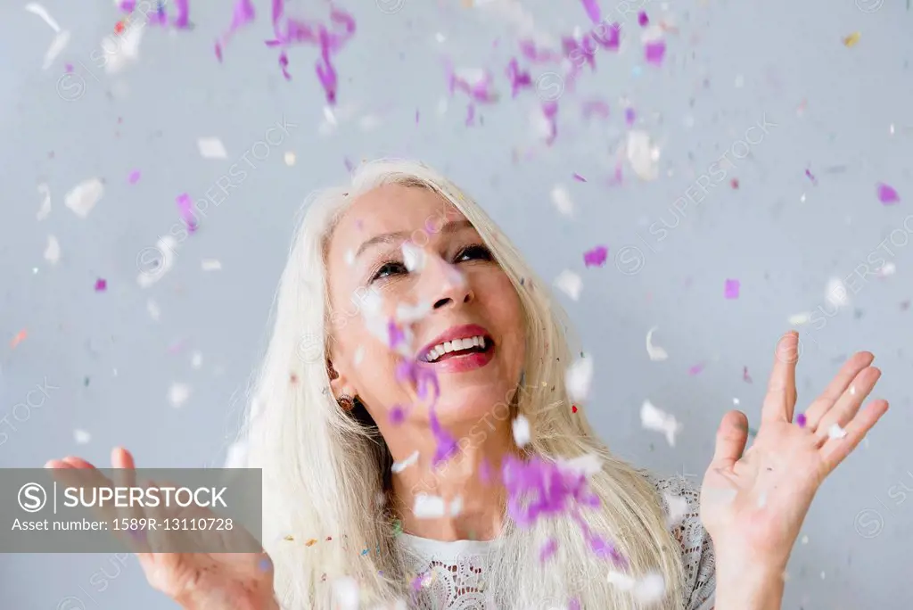 Caucasian woman throwing confetti