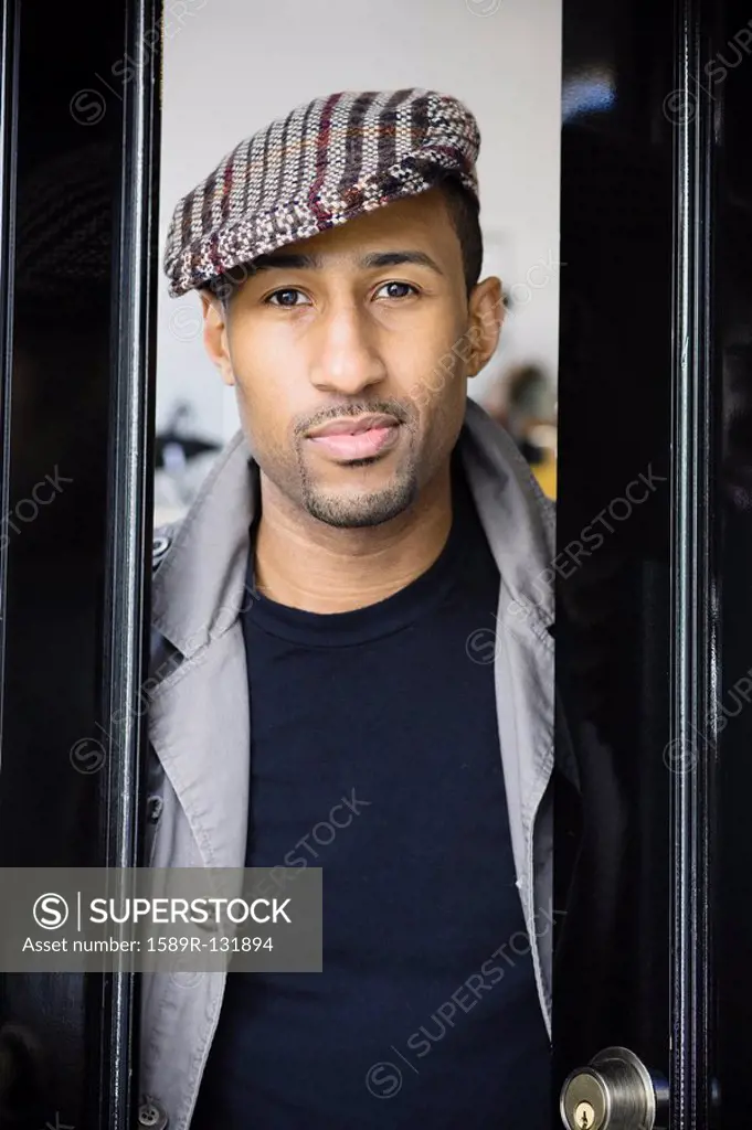 African American man wearing coat and cap