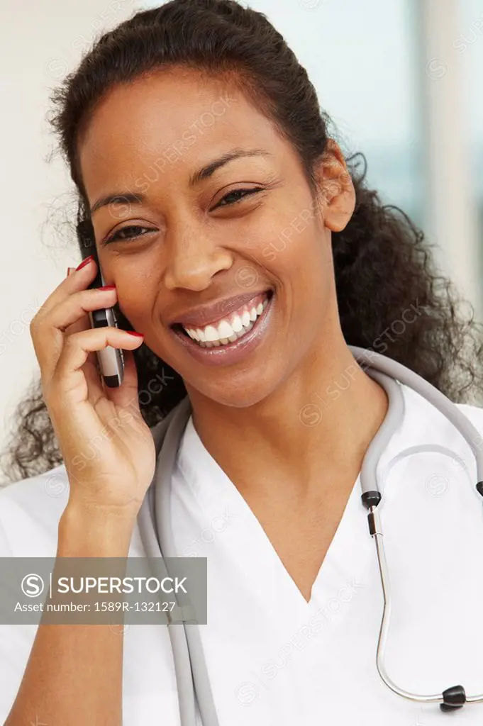 African American nurse talking on cell phone