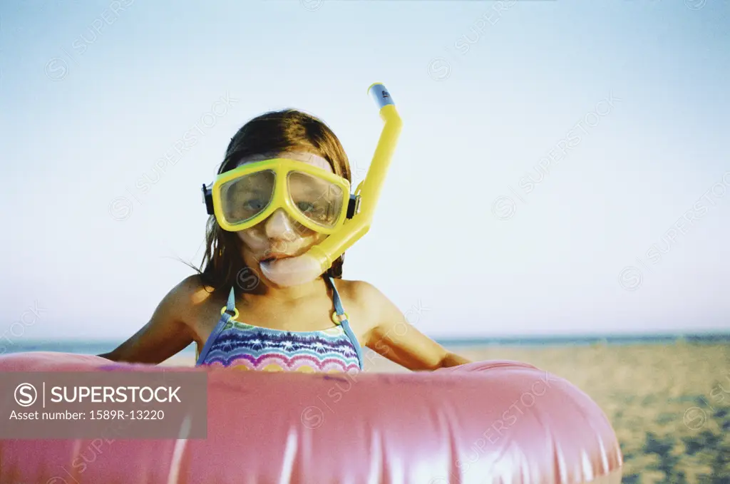Girl wearing snorkeling apparatus at the beach