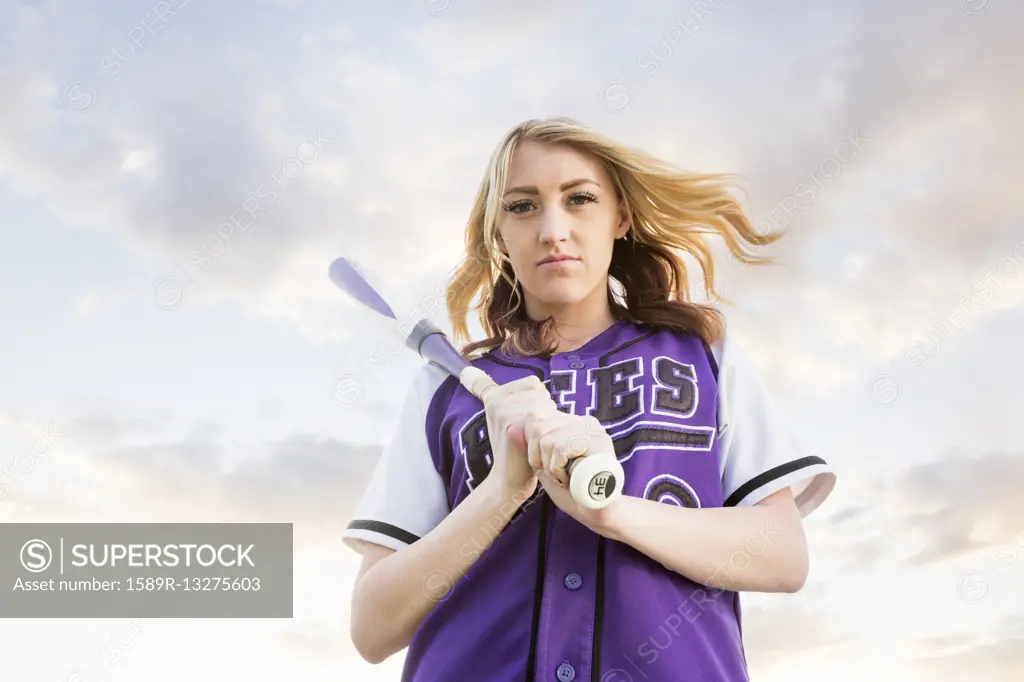 Caucasian teenage girl wearing softball uniform