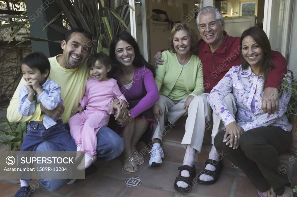 Hispanic family posing for a photo on a porch