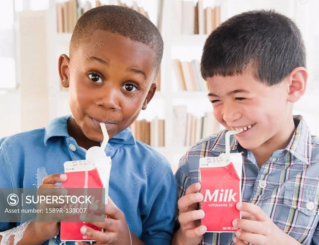 Boys drinking milk from carton
