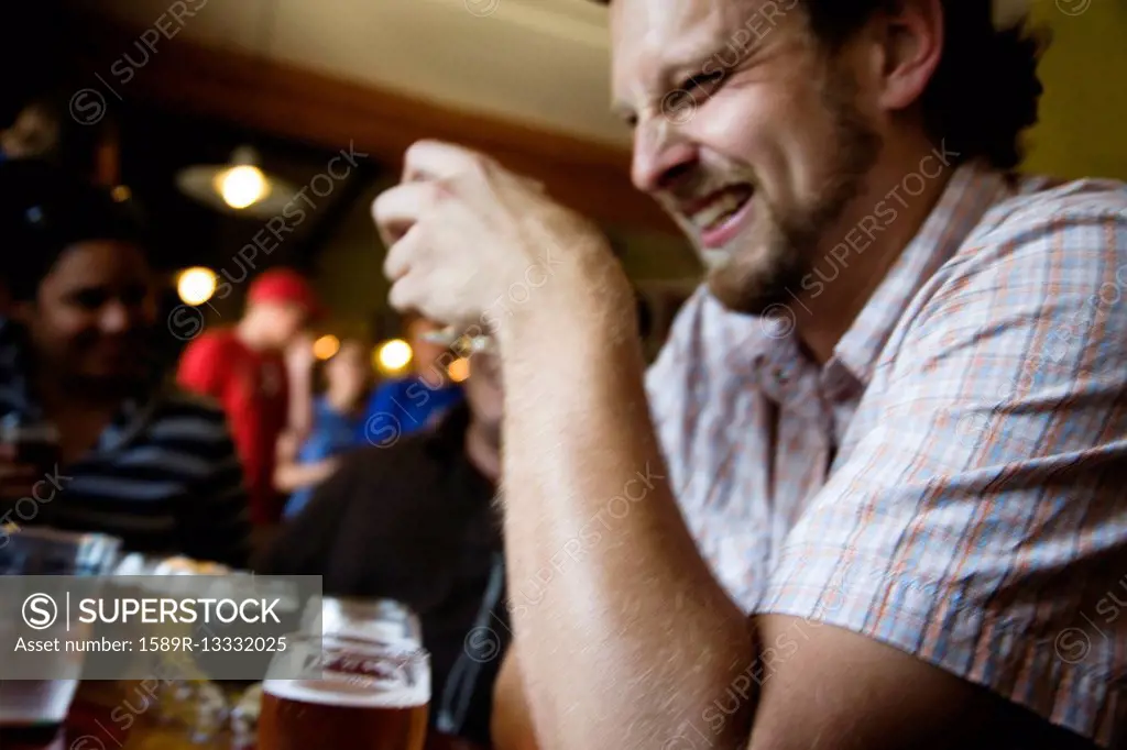 Caucasian man drinking in bar