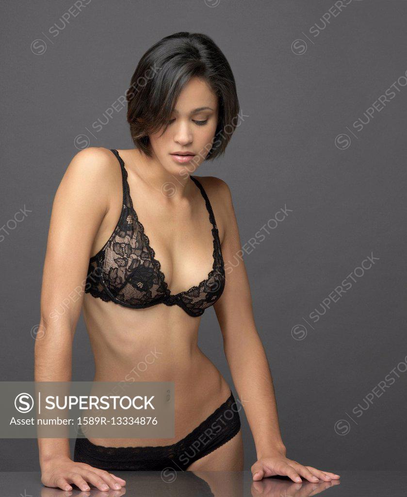 Mixed race woman wearing black bra and panties, Stock Photo