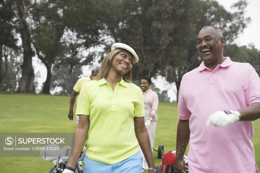 Two couples play golf together