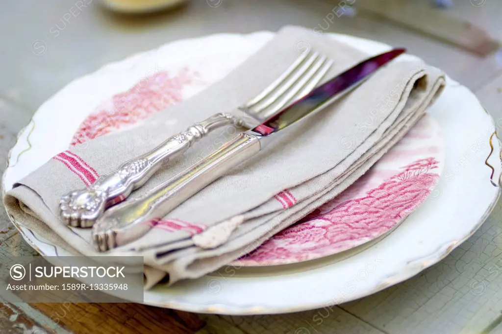 Silverware and napkin on plate