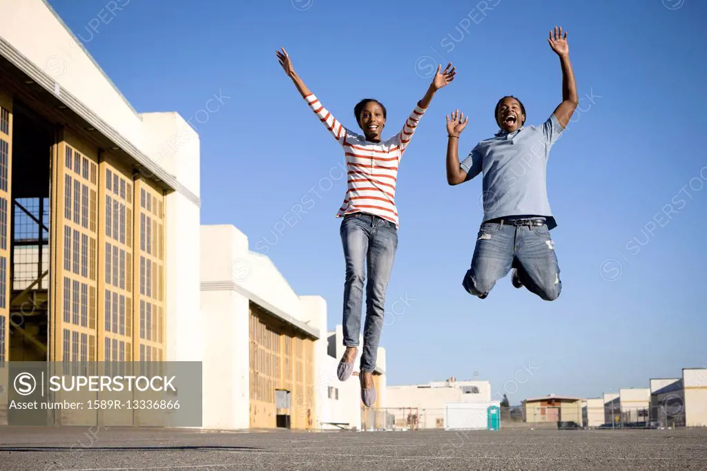 Black couple cheering and jumping