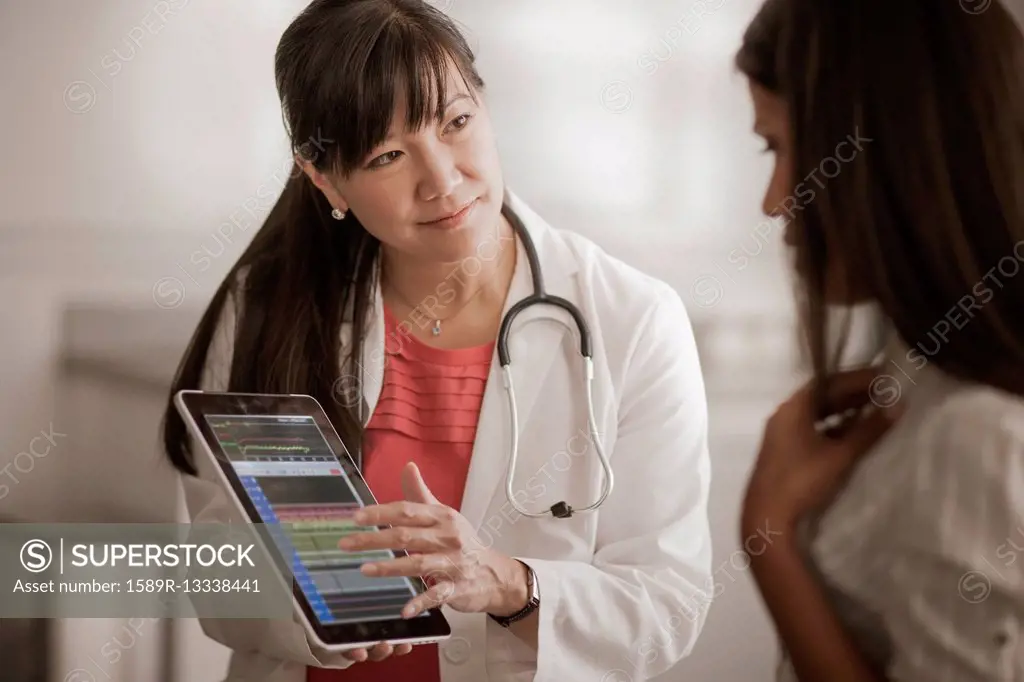 Doctor showing digital tablet to patient