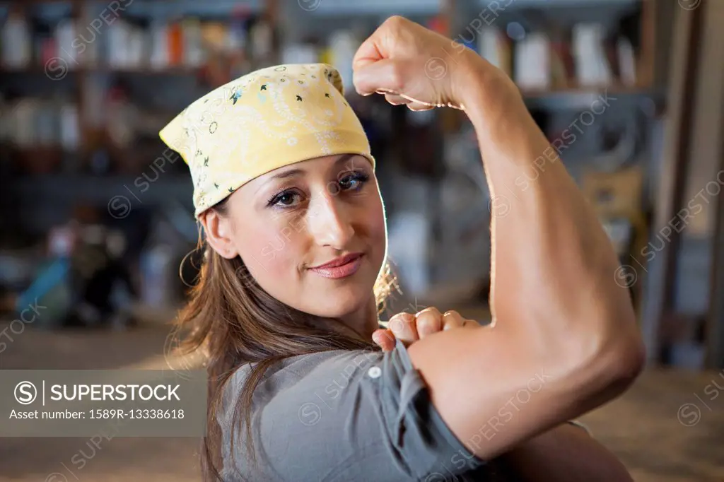 Hispanic worker flexing biceps